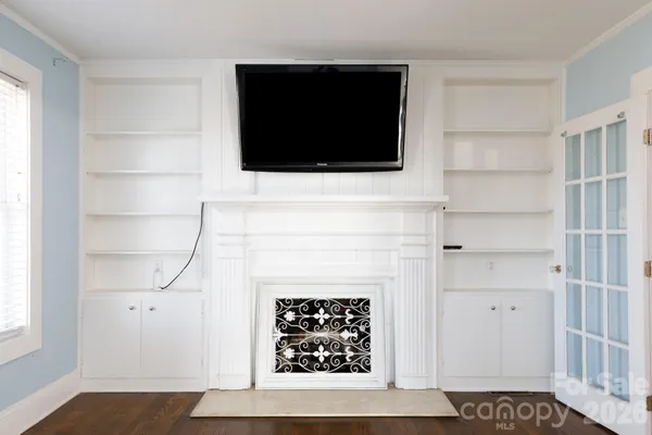 a living room with a fireplace and a flat screen tv