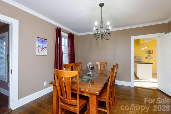 a view of a dining room with furniture wooden floor and chandelier