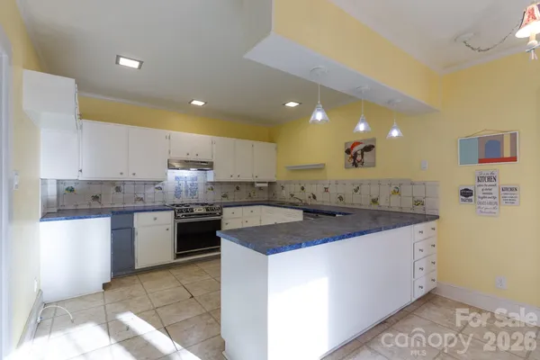 a kitchen with a sink stove and cabinets