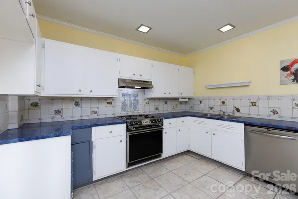 a kitchen with stainless steel appliances granite countertop a sink and cabinets