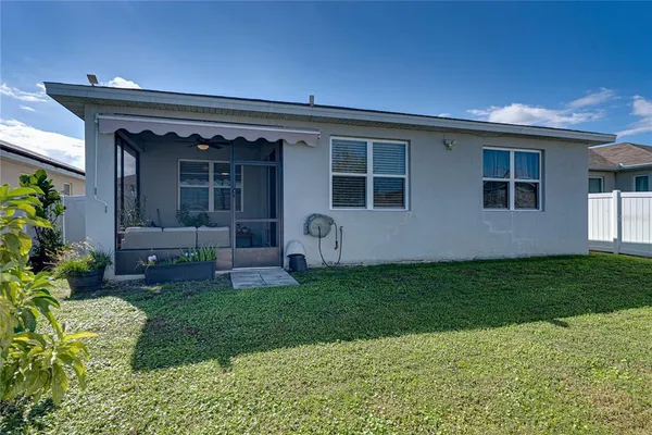 a view of a house with a backyard