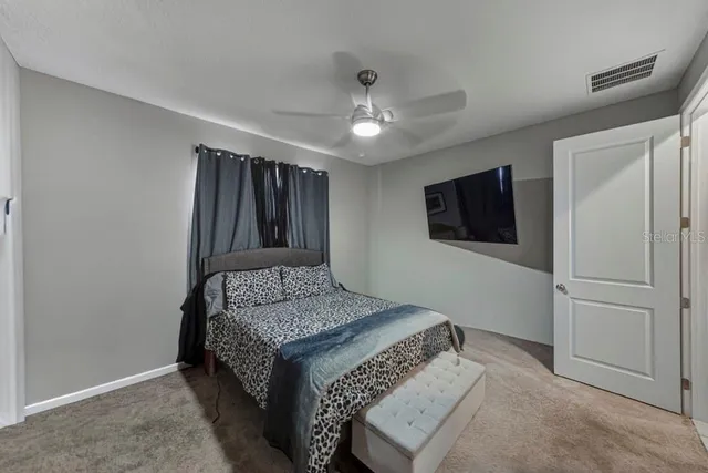 a bedroom with a bed and a television