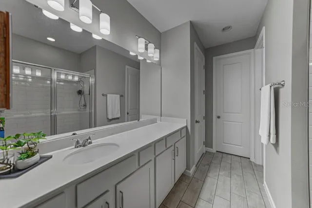 a bathroom with a sink double vanity and a shower