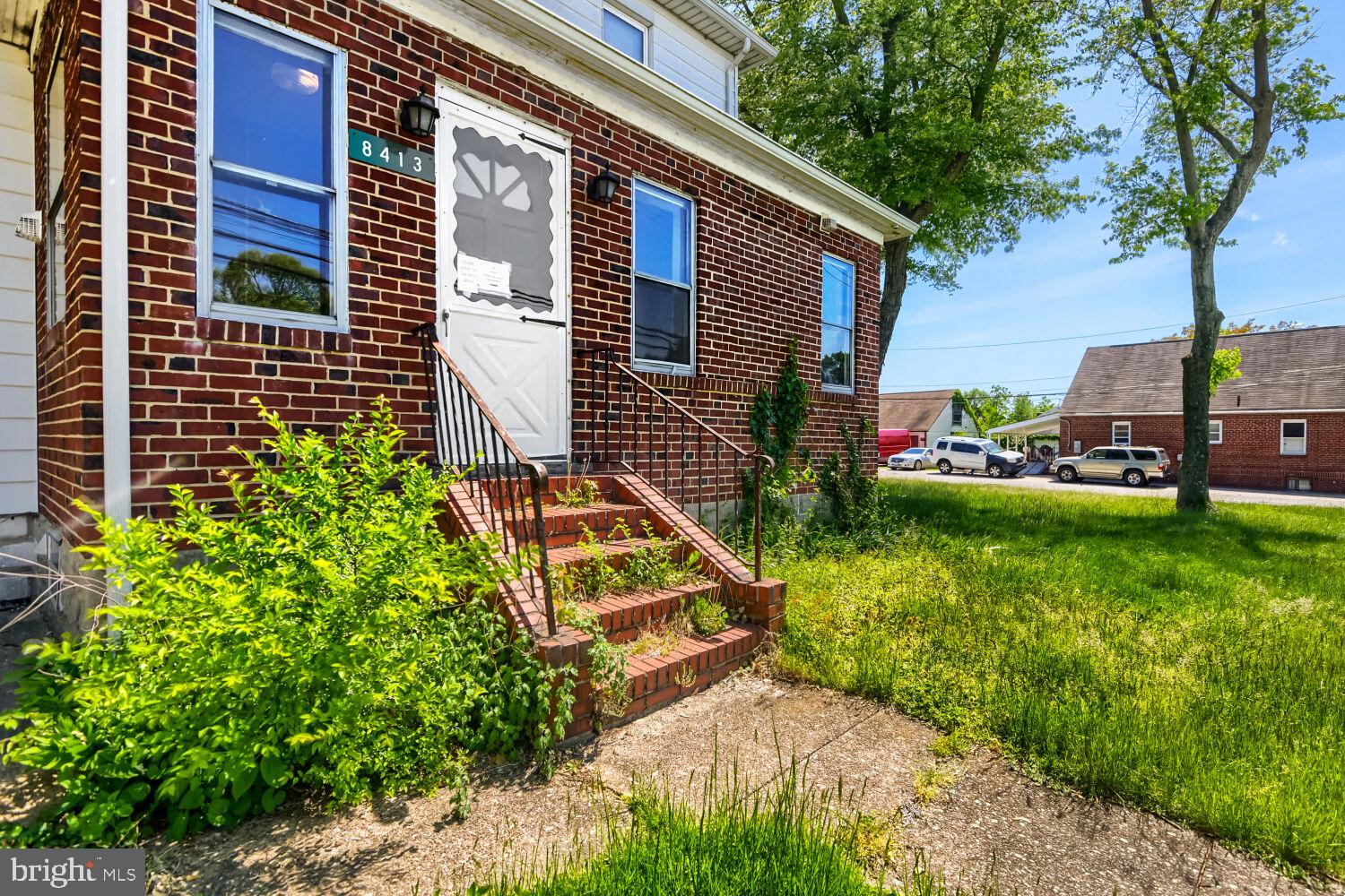 Charming brick facade with lush greenery.