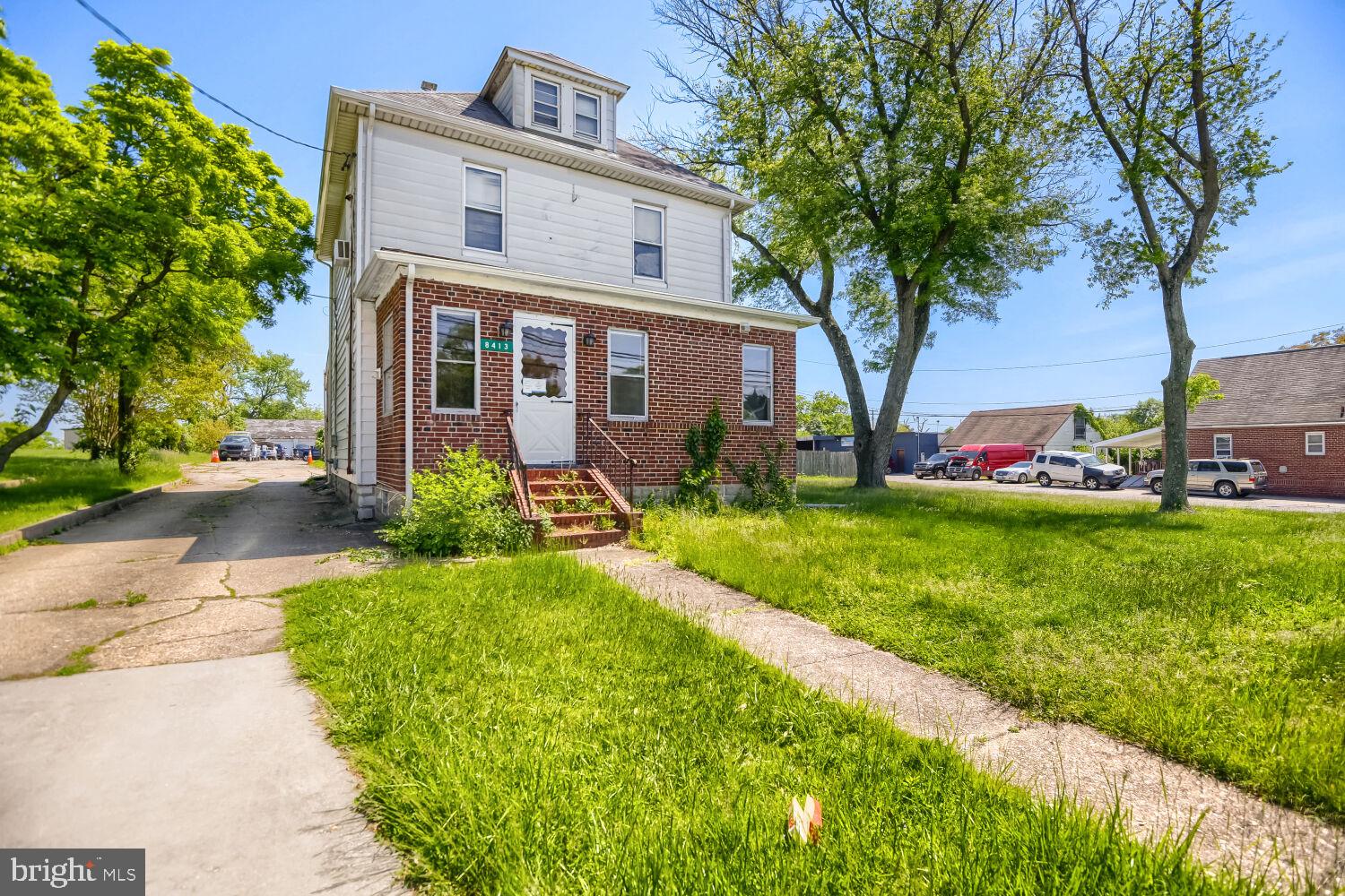 8413 Philadelphia Road Baltimore, MD 21237 - Photo 2 of 27 Charming brick home with lush greenery.