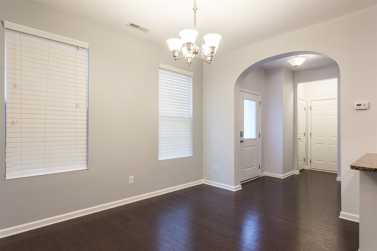 9929 Lynnberry Place Raleigh, NC 27617 - Photo 7 of 30 This lovely dining area is graced with an archway entry, elegant brushed nickel lighting, hardwood flooring, 2 single windows to add natural lighting and access to the screened-in porch. Dining Area