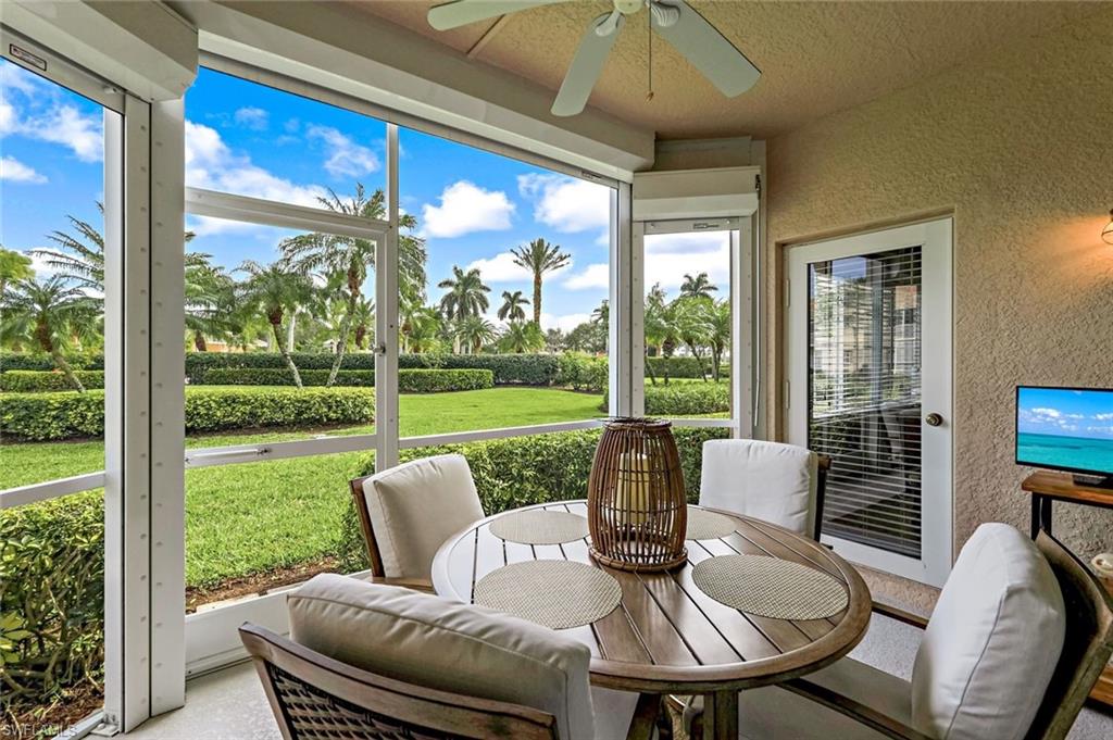 a view of a patio with a table chairs and a yard