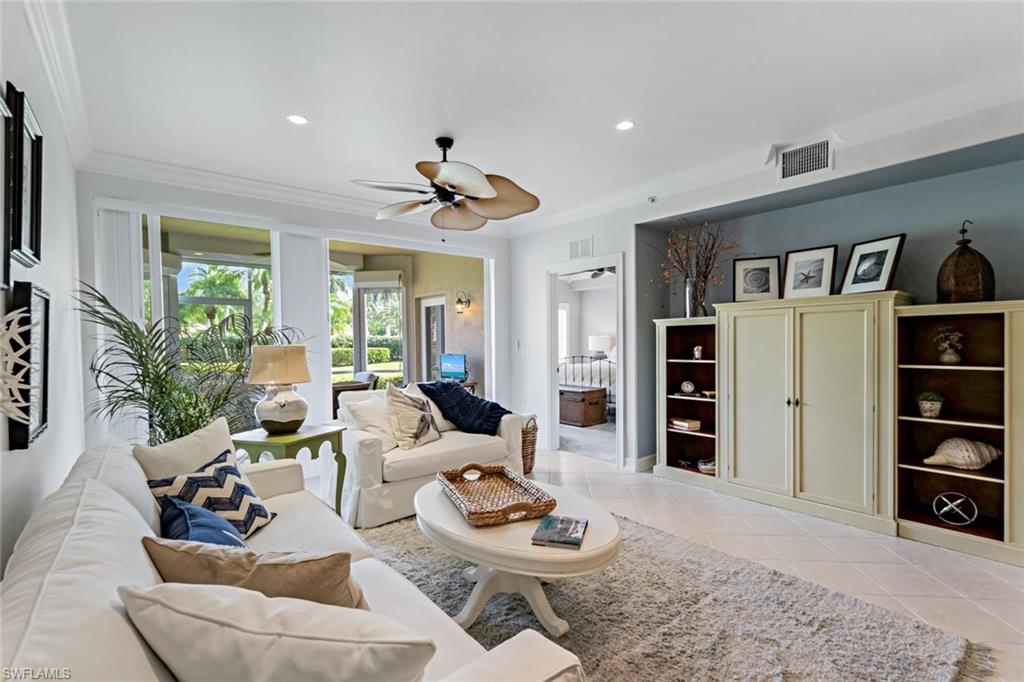 9128 Michael Circle, Unit 9903 Naples, FL 34113 - Photo 13 of 25 a living room with furniture and a flat screen tv