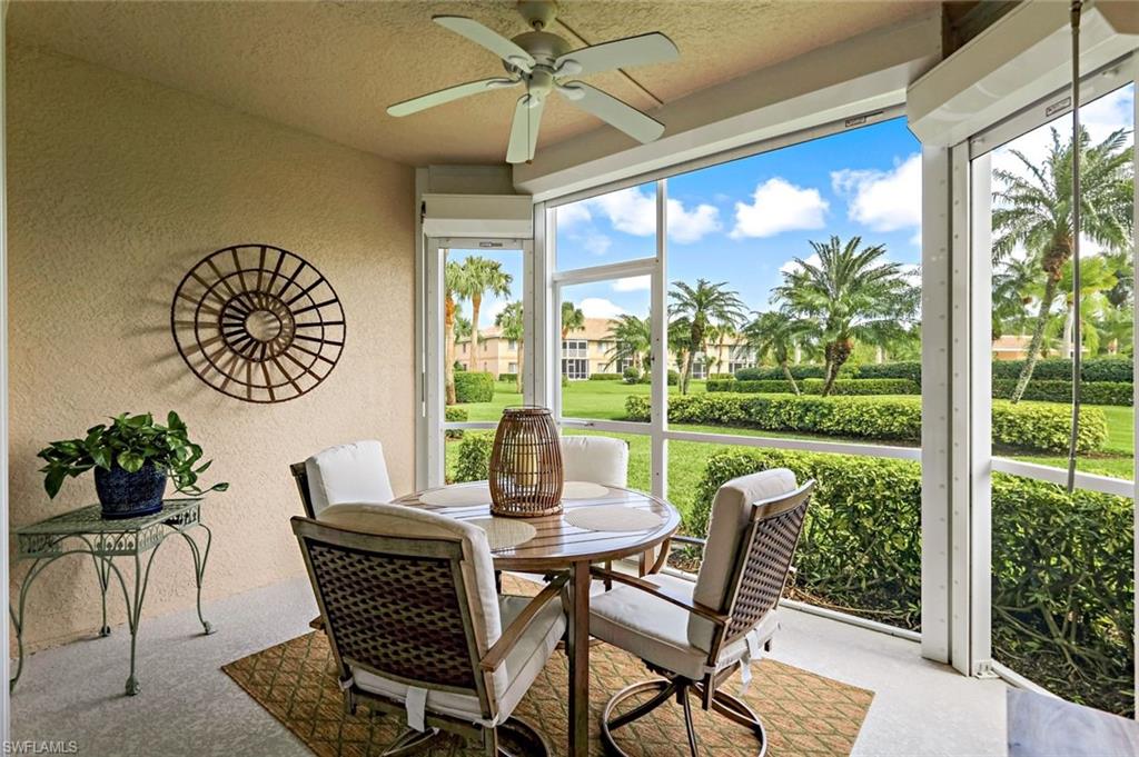 9128 Michael Circle, Unit 9903 Naples, FL 34113 - Photo 14 of 25 a dining room with furniture garden view and wooden floor
