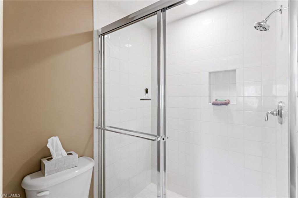 9128 Michael Circle, Unit 9903 Naples, FL 34113 - Photo 19 of 25 a bathroom with a shower