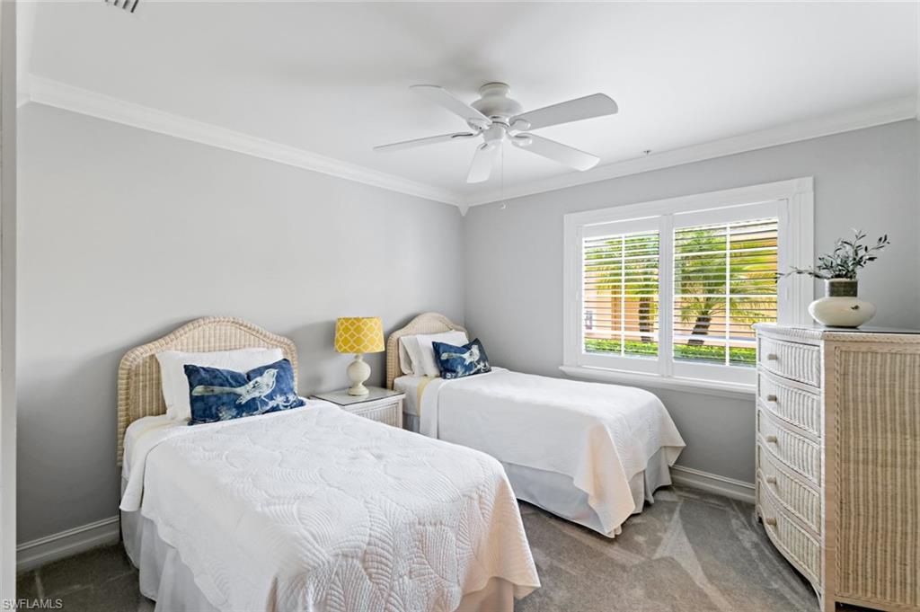 9128 Michael Circle, Unit 9903 Naples, FL 34113 - Photo 20 of 25 a bedroom with two beds and a window