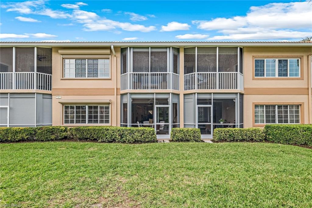 9128 Michael Circle, Unit 9903 Naples, FL 34113 - Photo 23 of 25 a front view of a house having yard