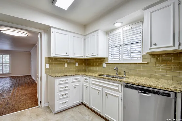a kitchen with a sink stove and cabinets