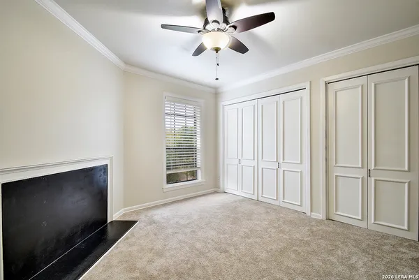 en empty room with windows and fan