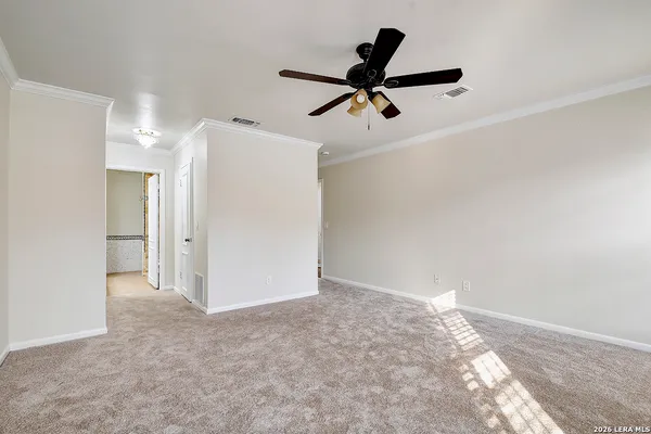 a view of a big room with closet and a ceiling fan