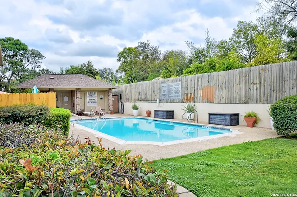 a view of a house with backyard and sitting area