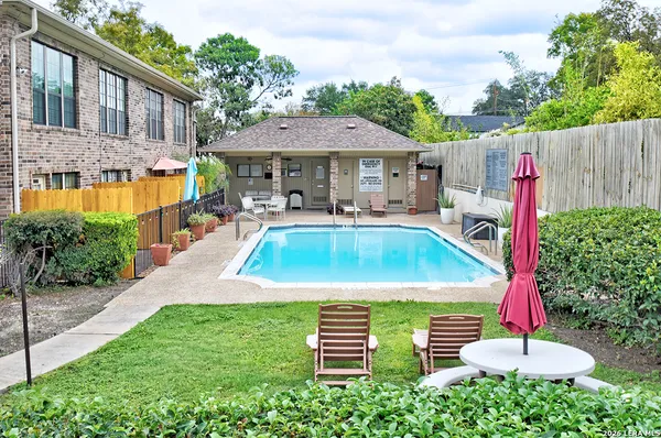 a front view of a house with swimming pool garden and patio