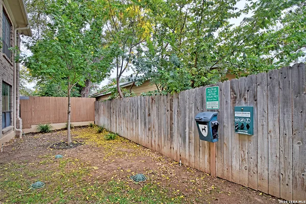 a backyard of a house with table and chairs
