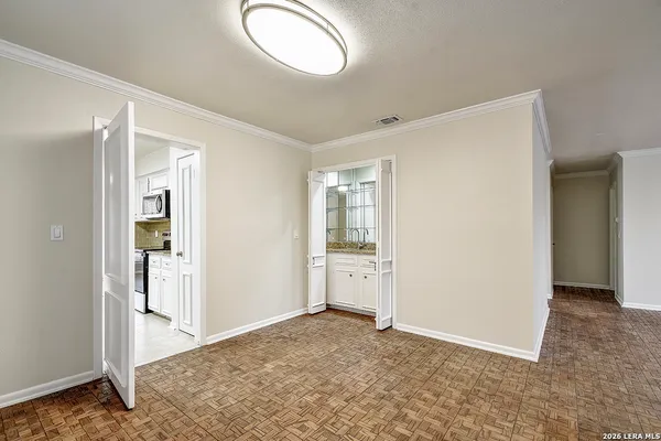 an empty room with window and wooden floor