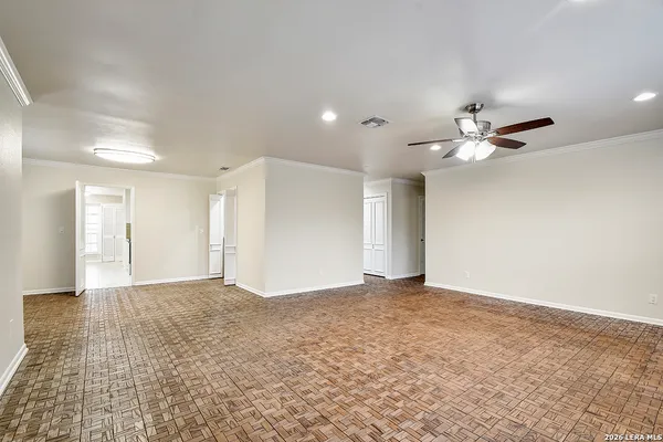 a view of an empty room with a ceiling fan