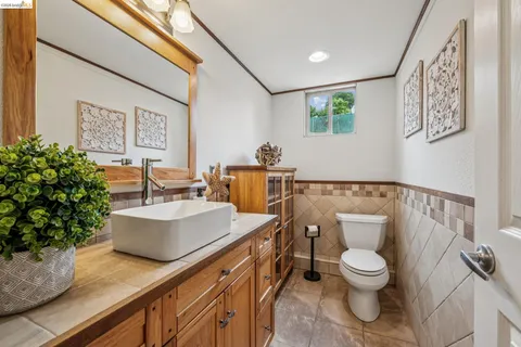 a white toilet sitting next to a bathroom sink