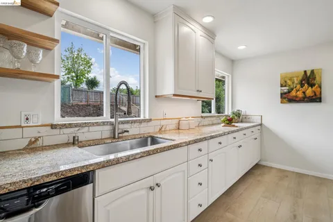 a kitchen with sink and cabinets