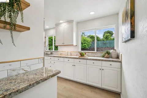 a kitchen with sink cabinets and window