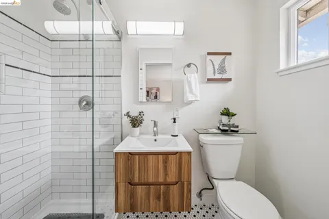 a white toilet sitting next to a bathroom sink