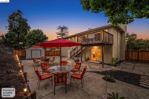 a backyard of a house with table and chairs