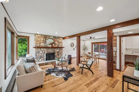 a living room with fireplace furniture and a floor to ceiling window