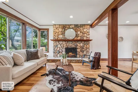 a living room with furniture a large window and a fireplace