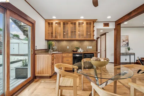 a dining room with furniture and a large window