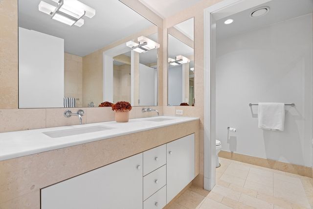 a bathroom with a double vanity sink mirror and double