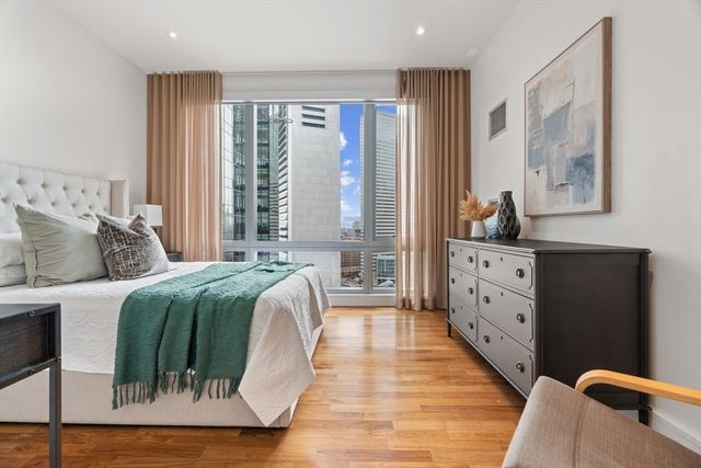 a living room with a bed furniture and a large window