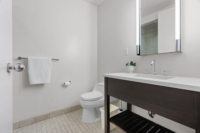 a bathroom with a sink toilet and mirror