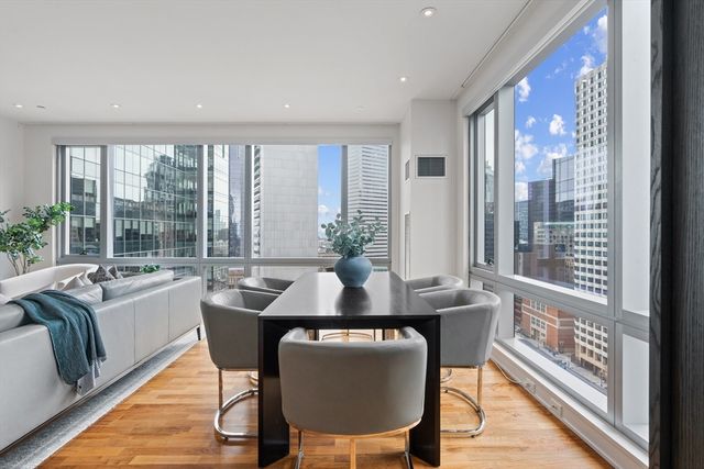 a dining room with furniture and wooden floor