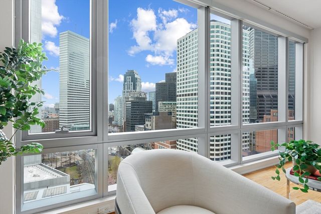 a view of a balcony with a couch and table and chairs