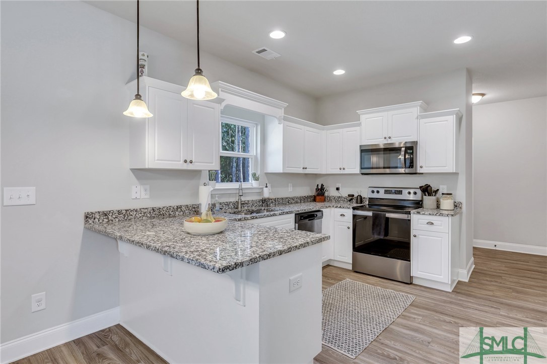 205 Crosswinds Drive Rincon, GA 31326 - Photo 13 of 37 Kitchen features granite island and Stainless Steel appliances