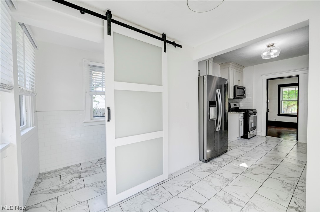 4464 Broadale Road Cleveland, OH 44109 - Photo 9 of 26 Kitchen with light tile flooring and stainless steel appliances
