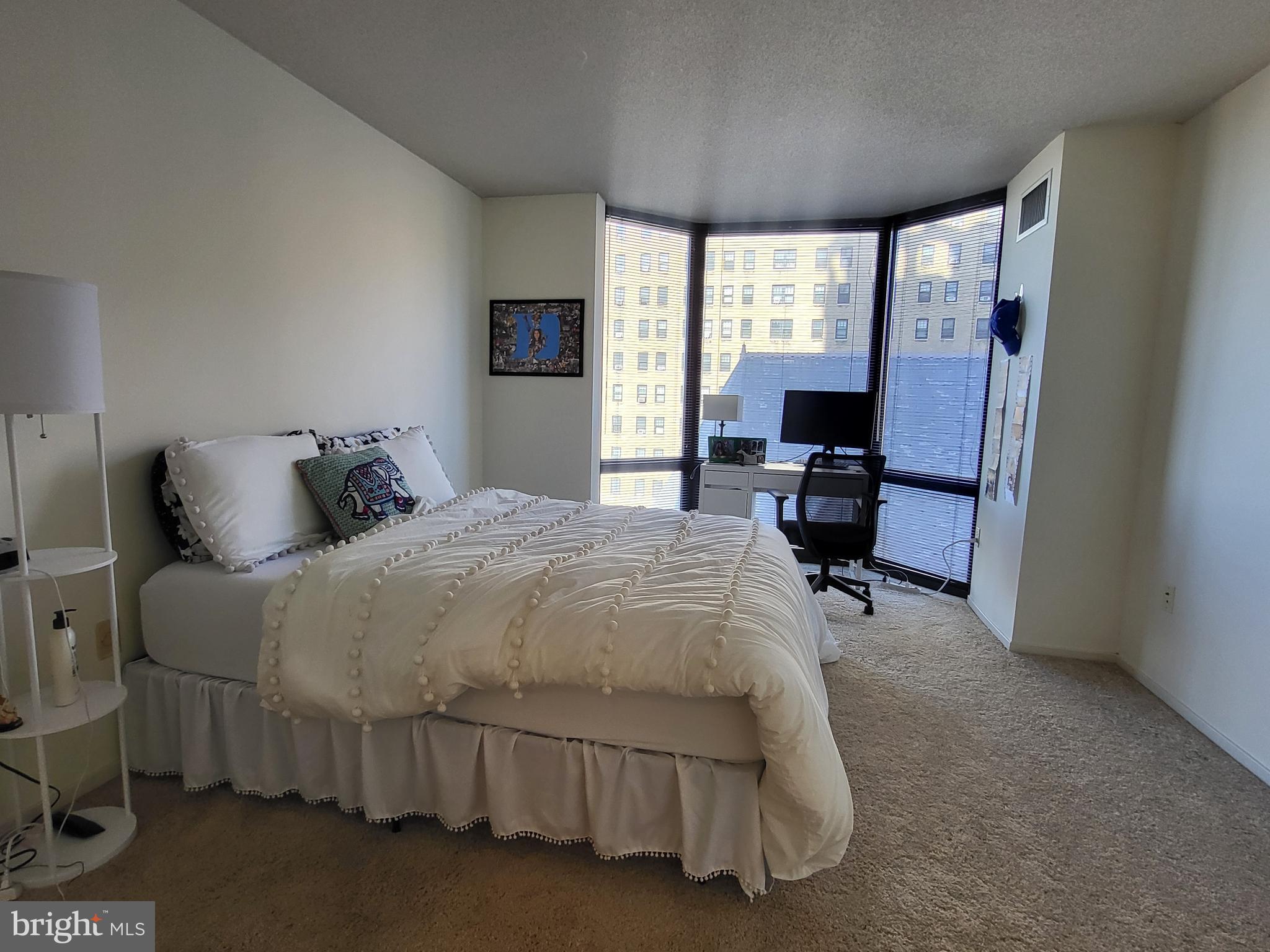2020 Walnut Street, Unit 8K Philadelphia, PA 19103 - Photo 4 of 19 a bedroom with a bed chair and a window