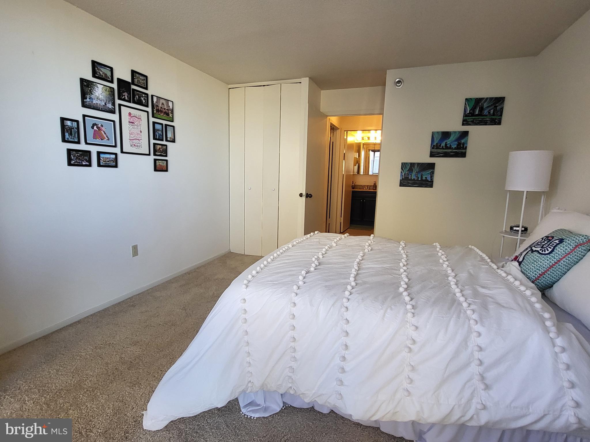 2020 Walnut Street, Unit 8K Philadelphia, PA 19103 - Photo 5 of 19 a bedroom with a bed and a lamp