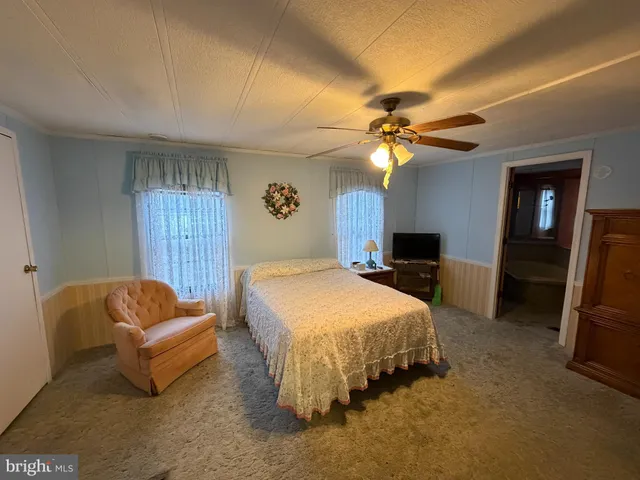 a spacious bedroom with a bed and a couch