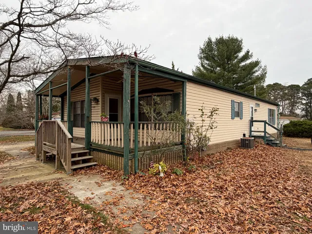 a view of a house with a yard and wooden fence