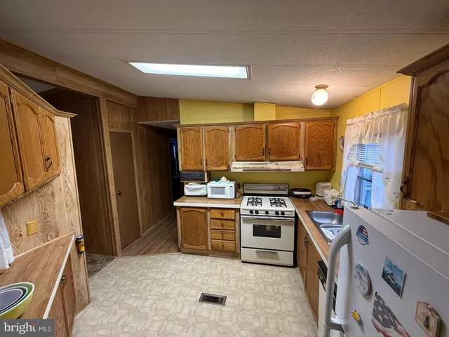 a kitchen with a refrigerator stove and sink