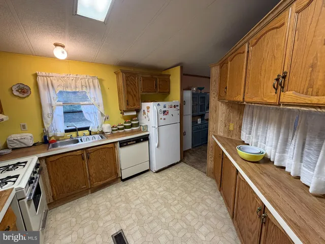 a kitchen with a sink stove and refrigerator