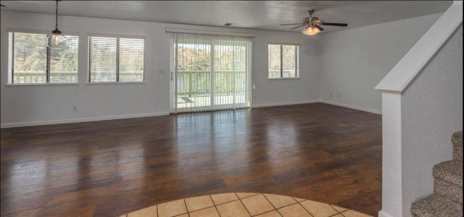 27817 Sky Harbour Road Friant, CA 93626 - Photo 13 of 36 an empty room with wooden floor and windows