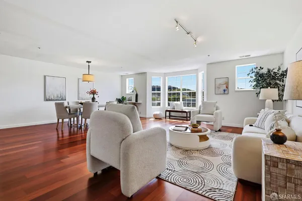 a living room with furniture wooden floor and a window