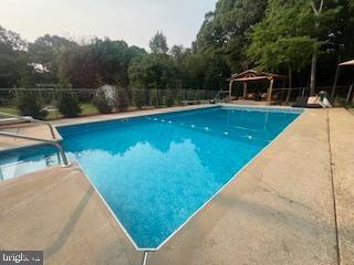 11064 Demarr Road White Plains, MD 20695 - Photo 64 of 98 a view of a swimming pool with a patio and a yard
