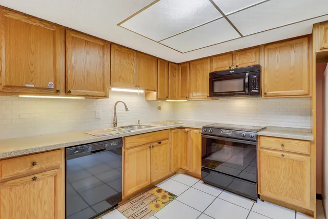 a kitchen with stainless steel appliances granite countertop a sink stove and microwave