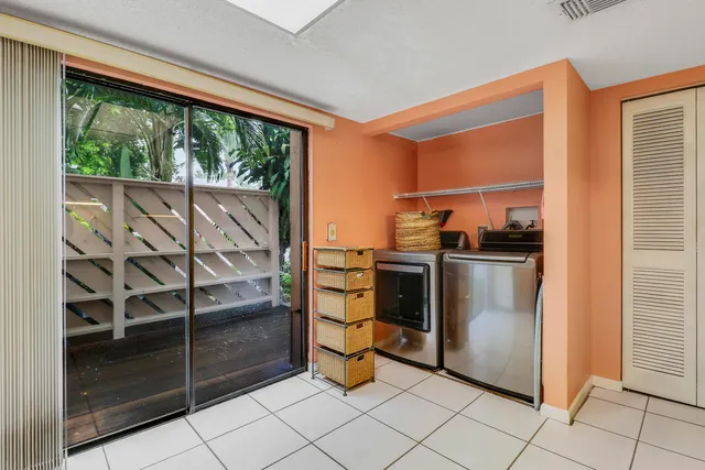 a kitchen with stainless steel appliances kitchen island granite countertop a refrigerator and a sink